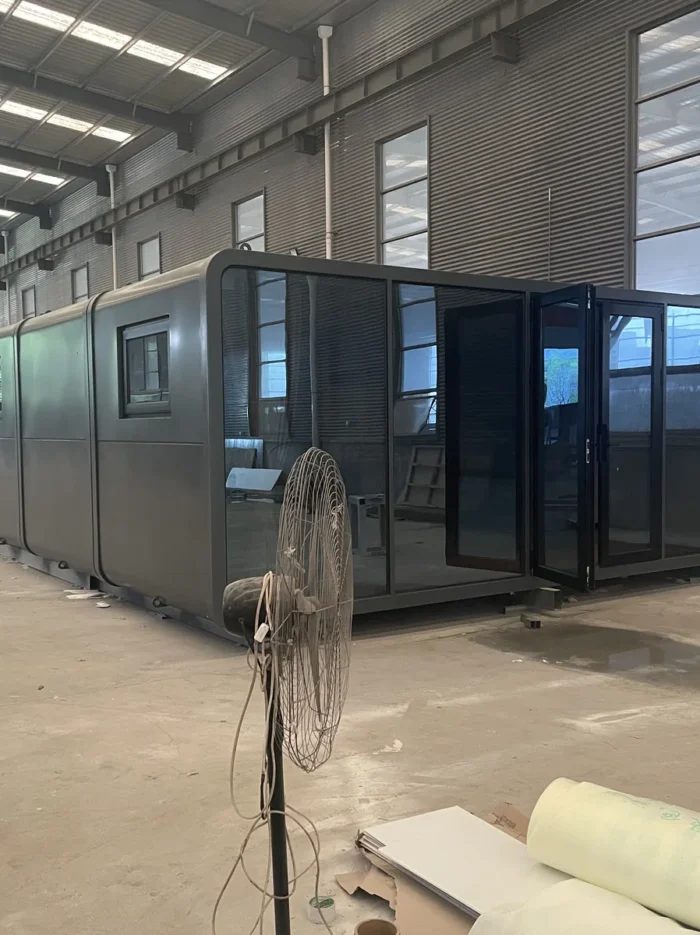 20ft dark gray Apple Cabin with panoramic glass entrance at the Zhengzhou Vision factory