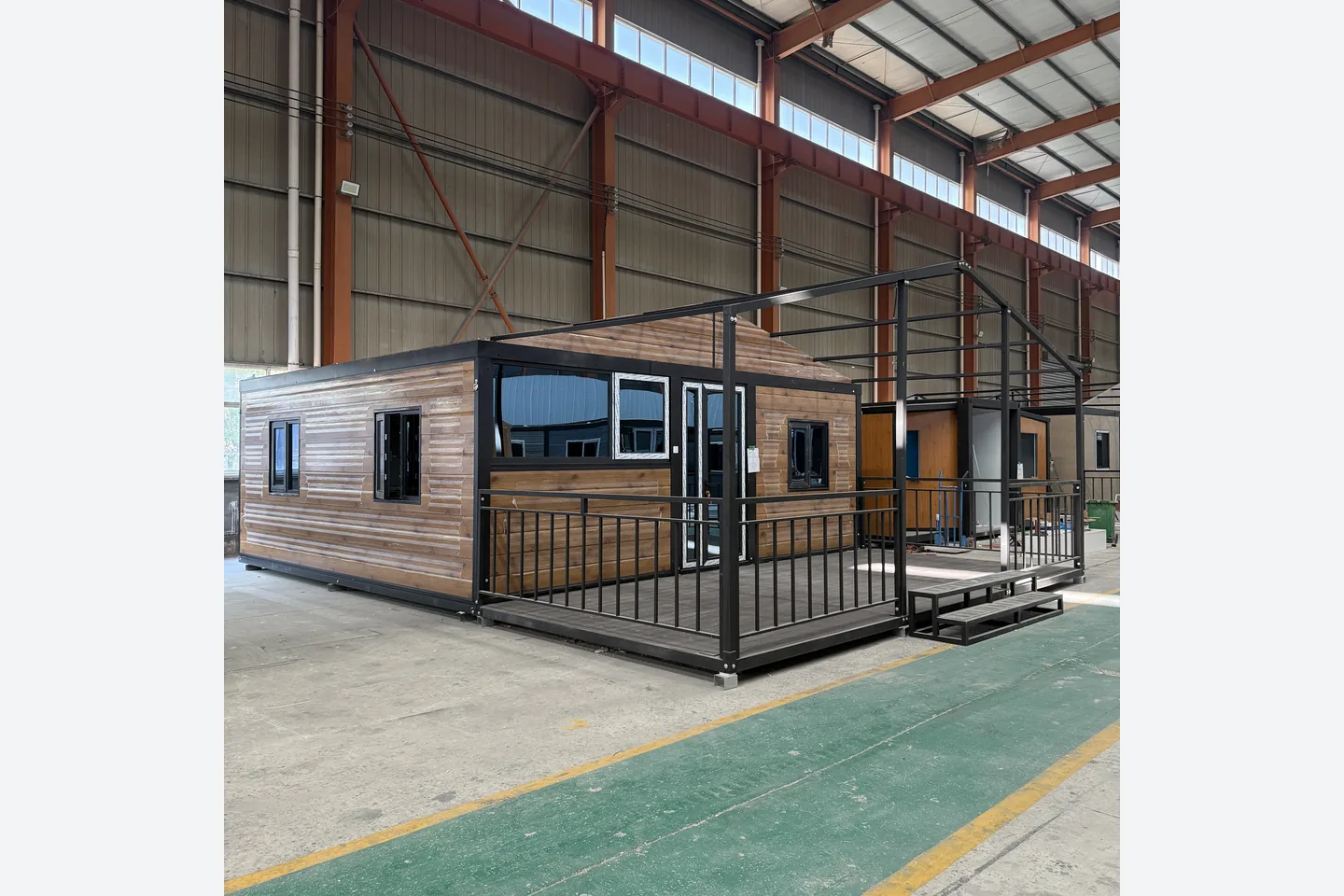 20ft folding prefab home with wood exterior black frame porch and railings