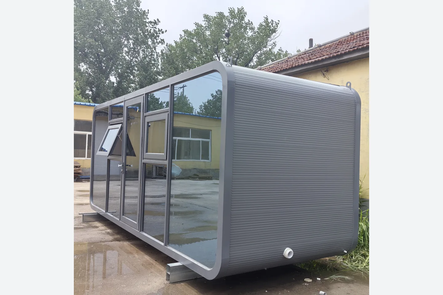gray metal carved panel prefab cabin with curved end wall