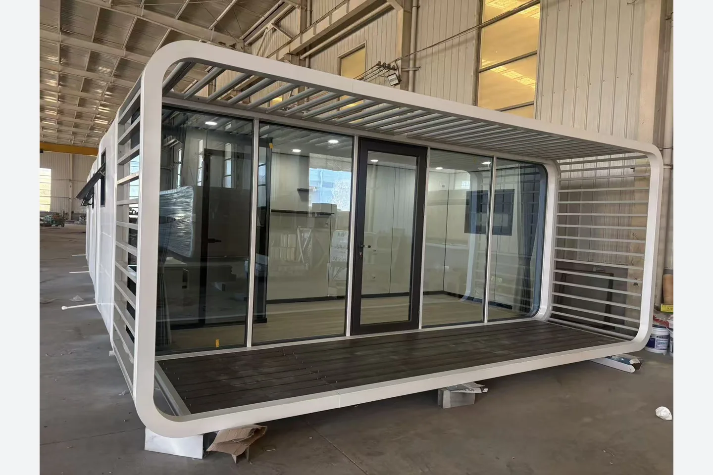 20ft modular tiny cabin with insulated glass facade and dark terrace deck