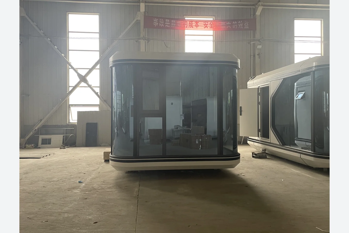 curved glass front facade of a 20ft prefab capsule house