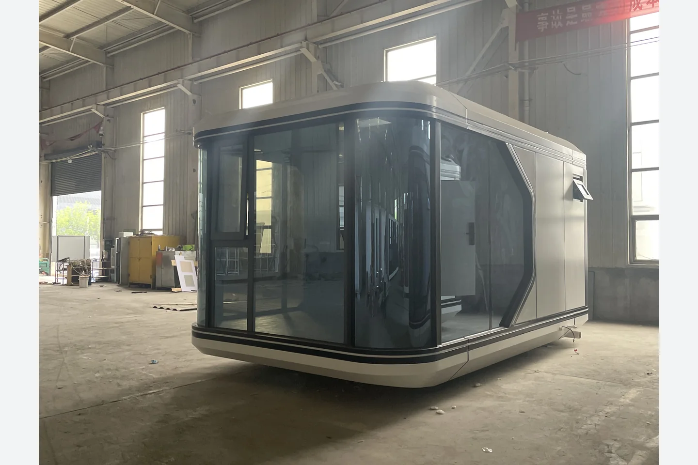 20ft white Apple Cabin space capsule pod with curved panoramic glass facade