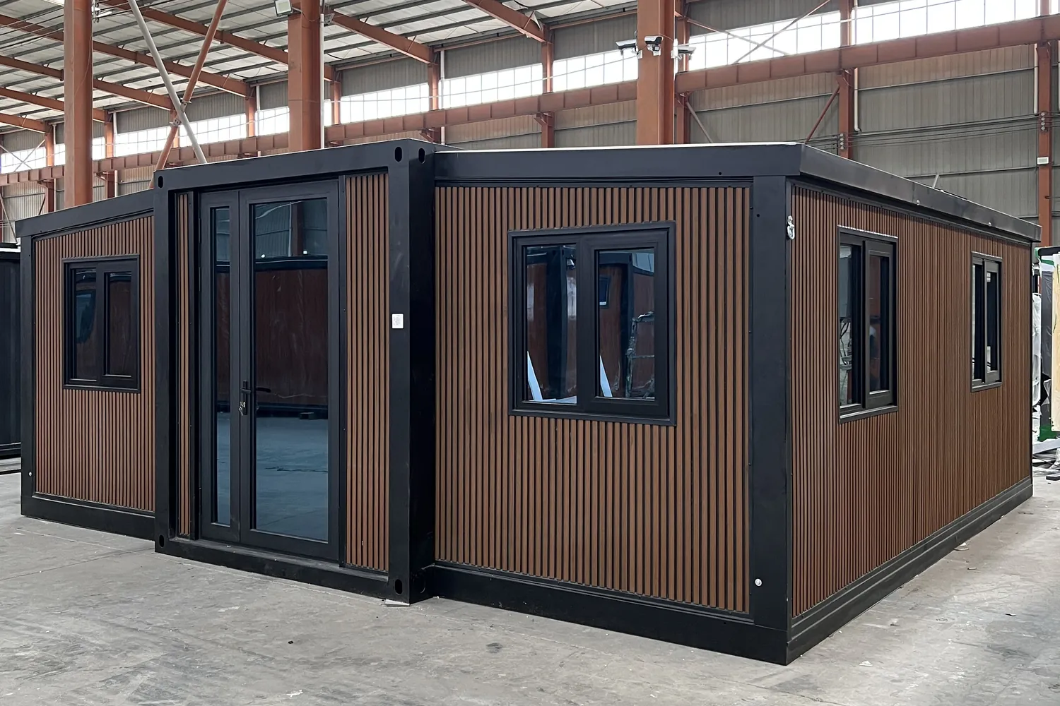 20ft wood grain expandable container house with black frame and vertical fluted exterior cladding
