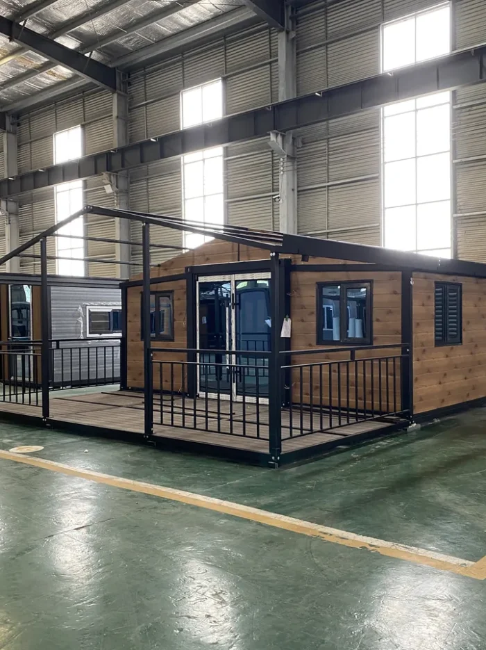 20ft Wood Grain Expandable House with Veranda - Factory View 20ft wood grain expandable container house with black frame and wraparound veranda