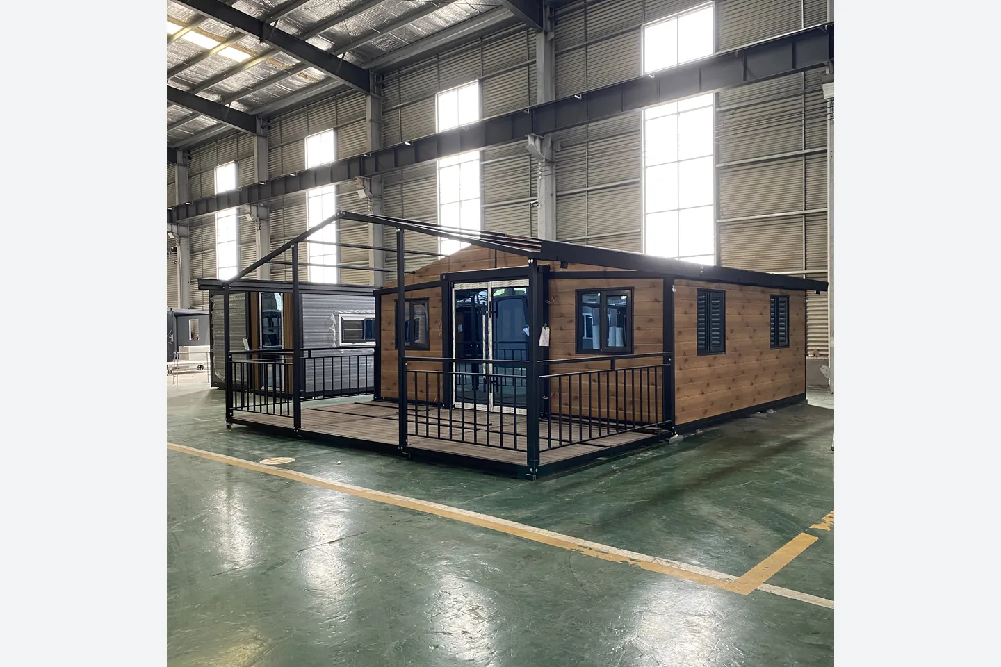 20ft wood grain expandable container house with black frame and wraparound veranda