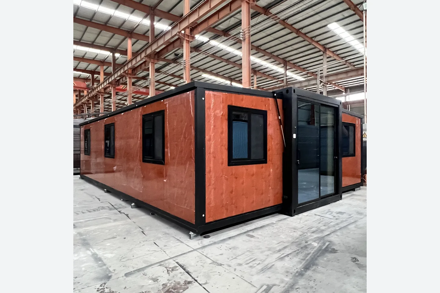 30ft double wing modular house with red wood grain panels and glazed entrance