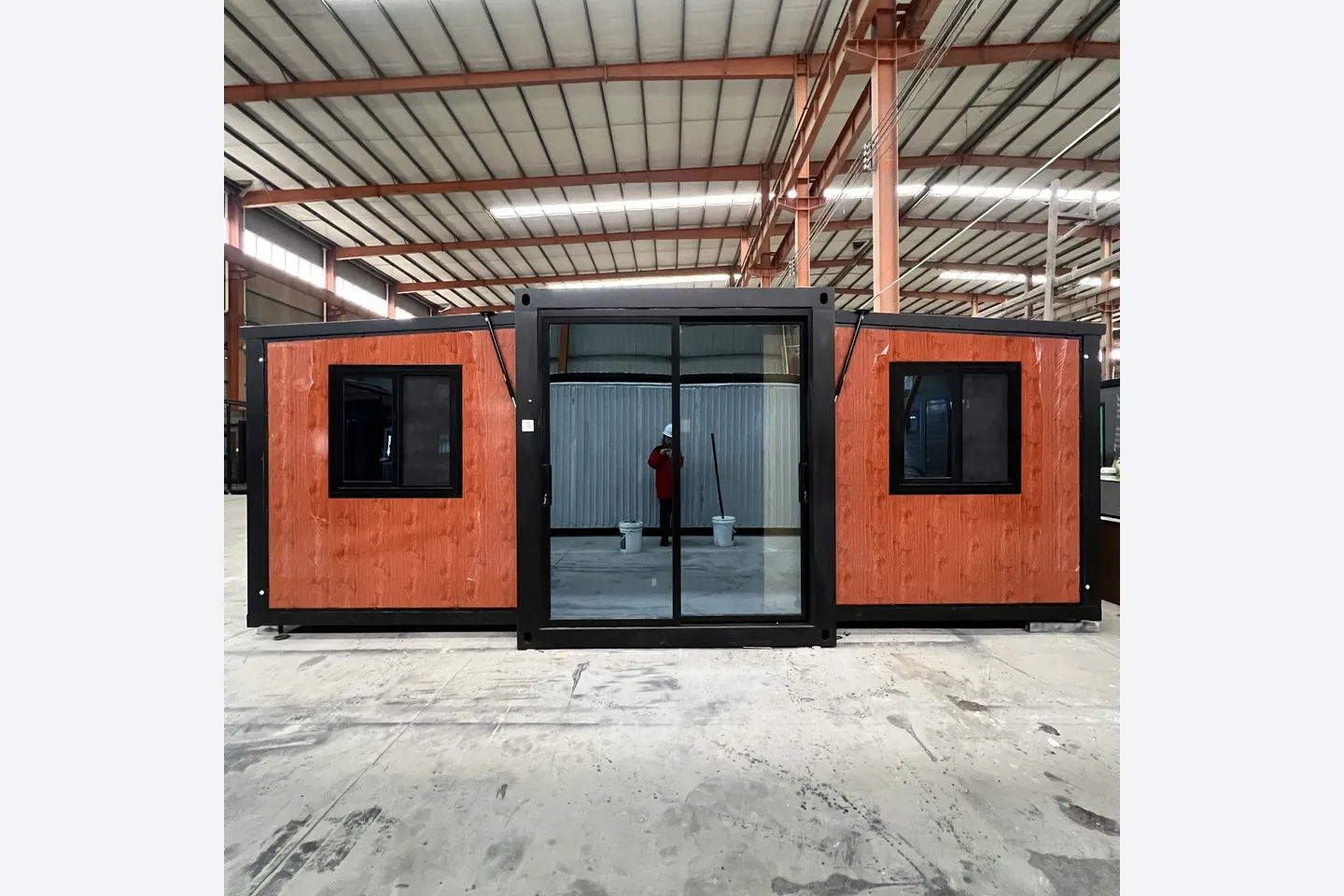 30ft expandable container home with central black framed glass entrance