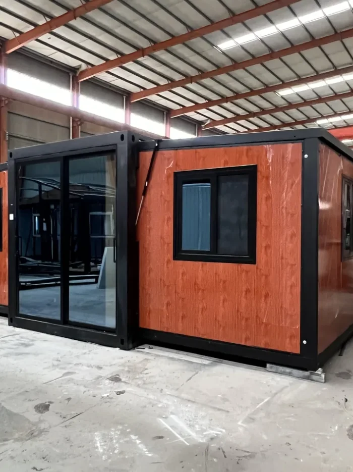 30ft Pine Knot Expandable House - Front 30ft pine knot wood grain double wing expandable house with black frame