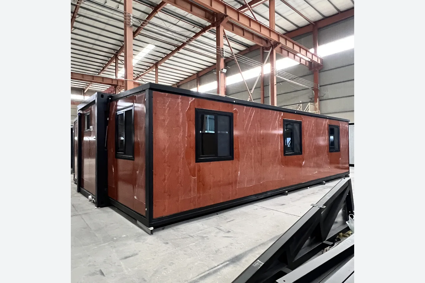 30ft three bedroom prefab house with red pine knot exterior and black windows