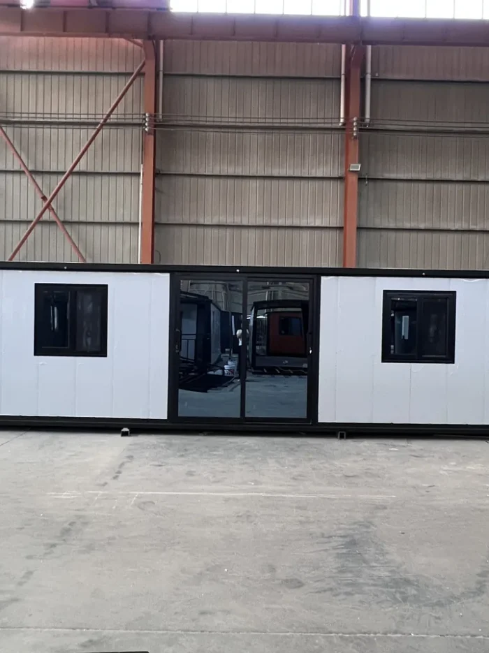 30ft White EPS Expandable House - Front 30ft white EPS double wing expandable house with black frame