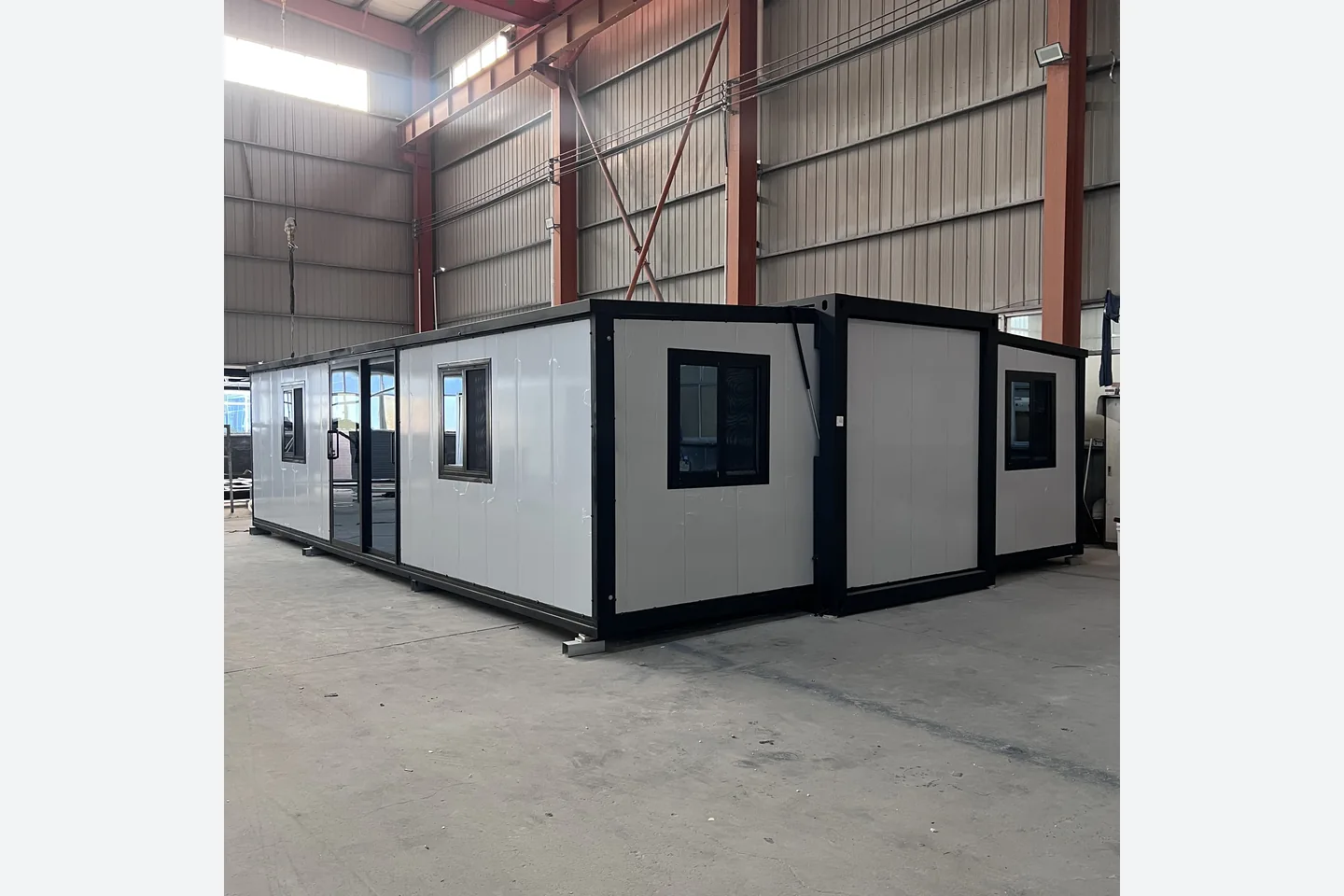 30ft white modular house with black steel frame and multiple windows