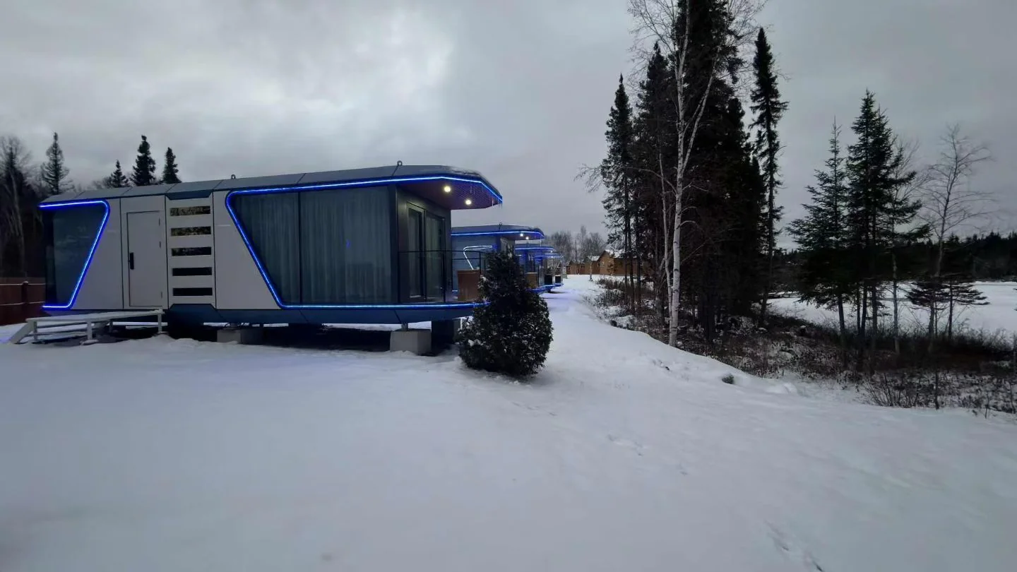38 square meter Space Capsule Cabin with blue LED outline at a winter resort