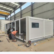 workers installing panoramic glass frames on a 40ft white Apple Cabin in the factory