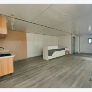 open-plan interior of a 40ft Apple Cabin with wood-look kitchen cabinets and island counter
