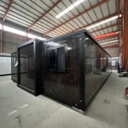 rear view of 40ft black walnut folding prefab home with black windows