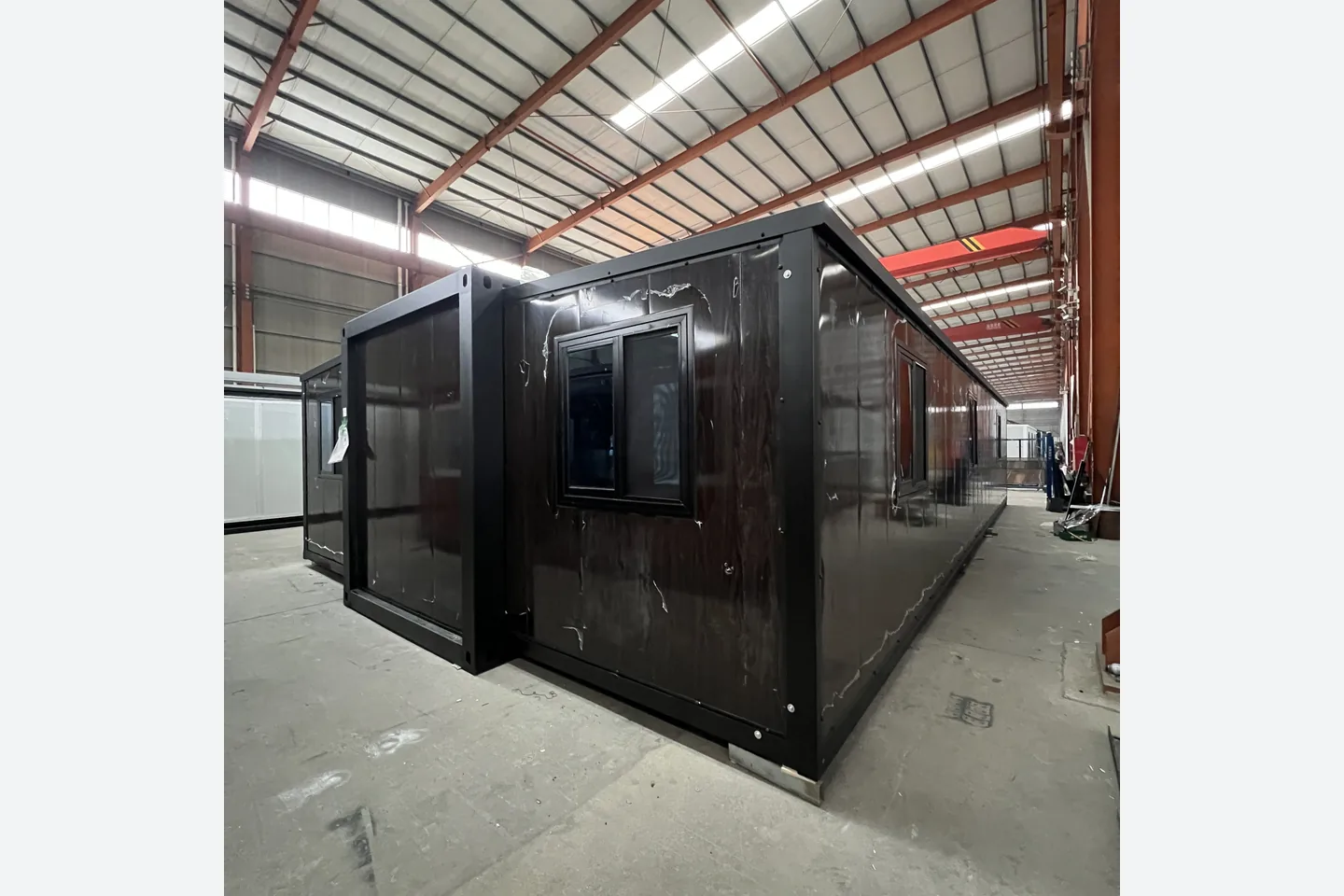 rear view of 40ft black walnut folding prefab home with black windows