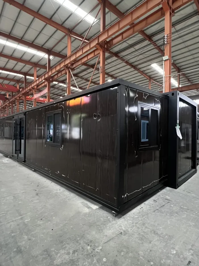 40ft Modular Container Home - Factory View 40ft modular container home with black frame and walnut finish