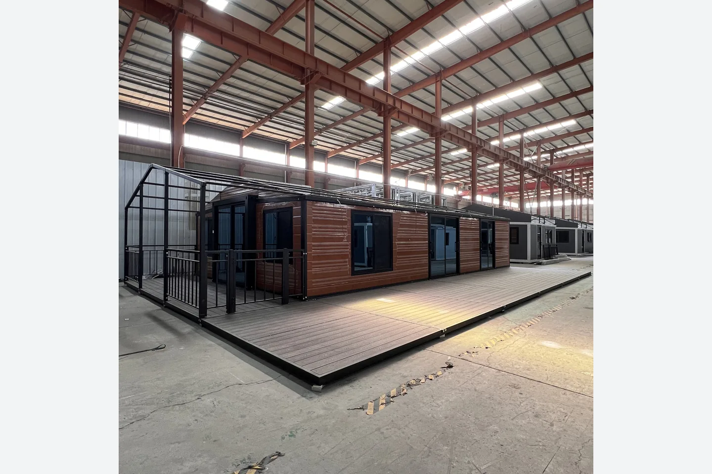 40ft wood grain expandable container house with black frame and full length front deck