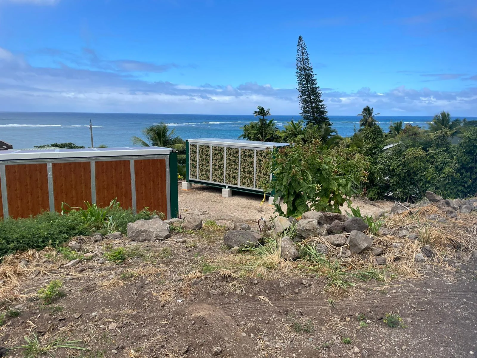 Multiple folding container house units at a coastal project site in Guadeloupe