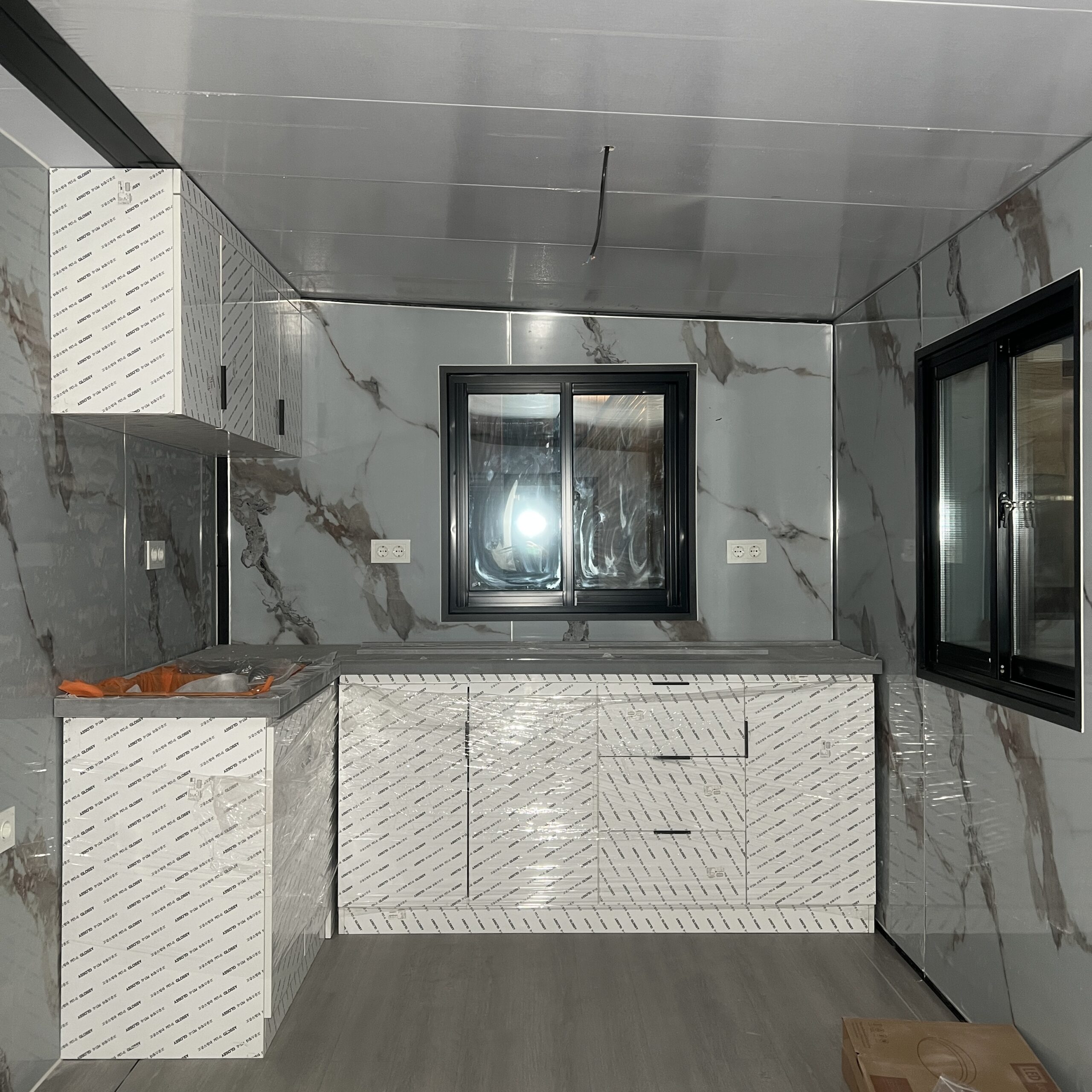 Prefab house kitchen cabinets and windows during factory inspection