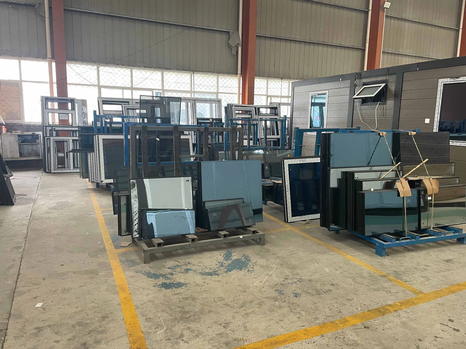 Window and door components prepared for prefab house assembly
