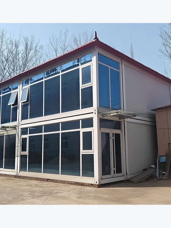 corner view of a two-floor quick-assembly container building with opening windows and glass facade