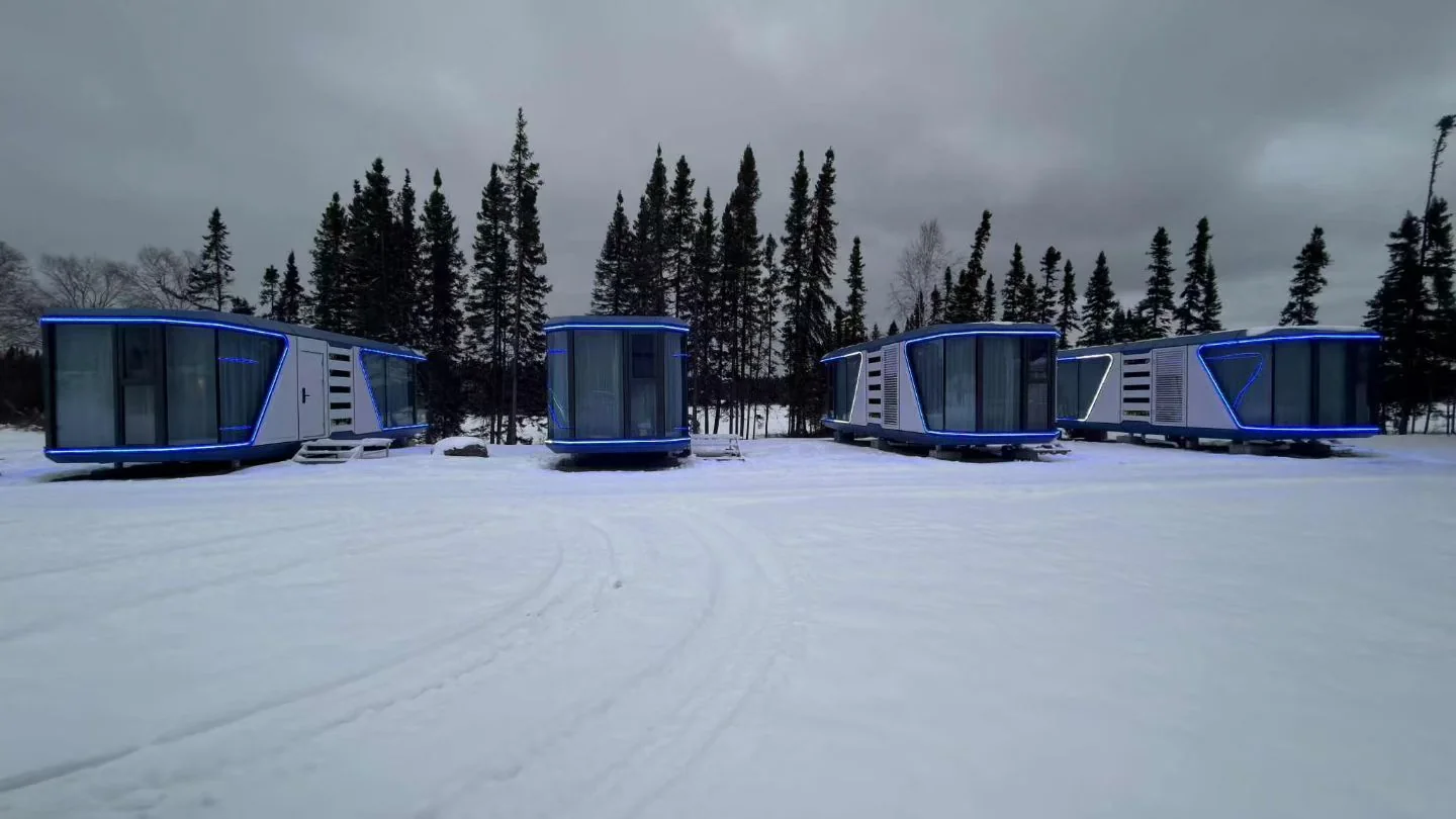 multiple prefab Space Capsule hotel pods installed in a snowy forest resort