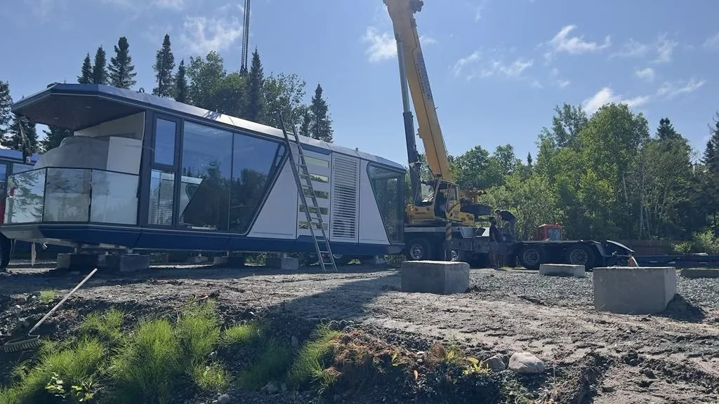 crane and foundation work during installation of a prefab Space Capsule House