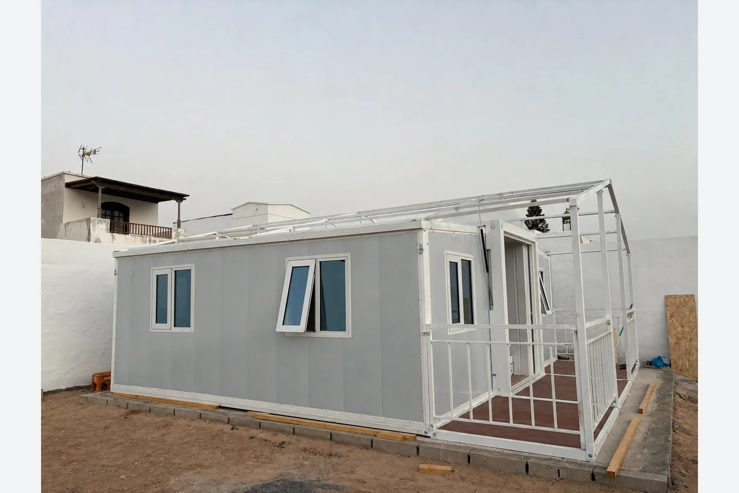 side view of a 20ft expandable prefab house with balcony roof frame and opening windows