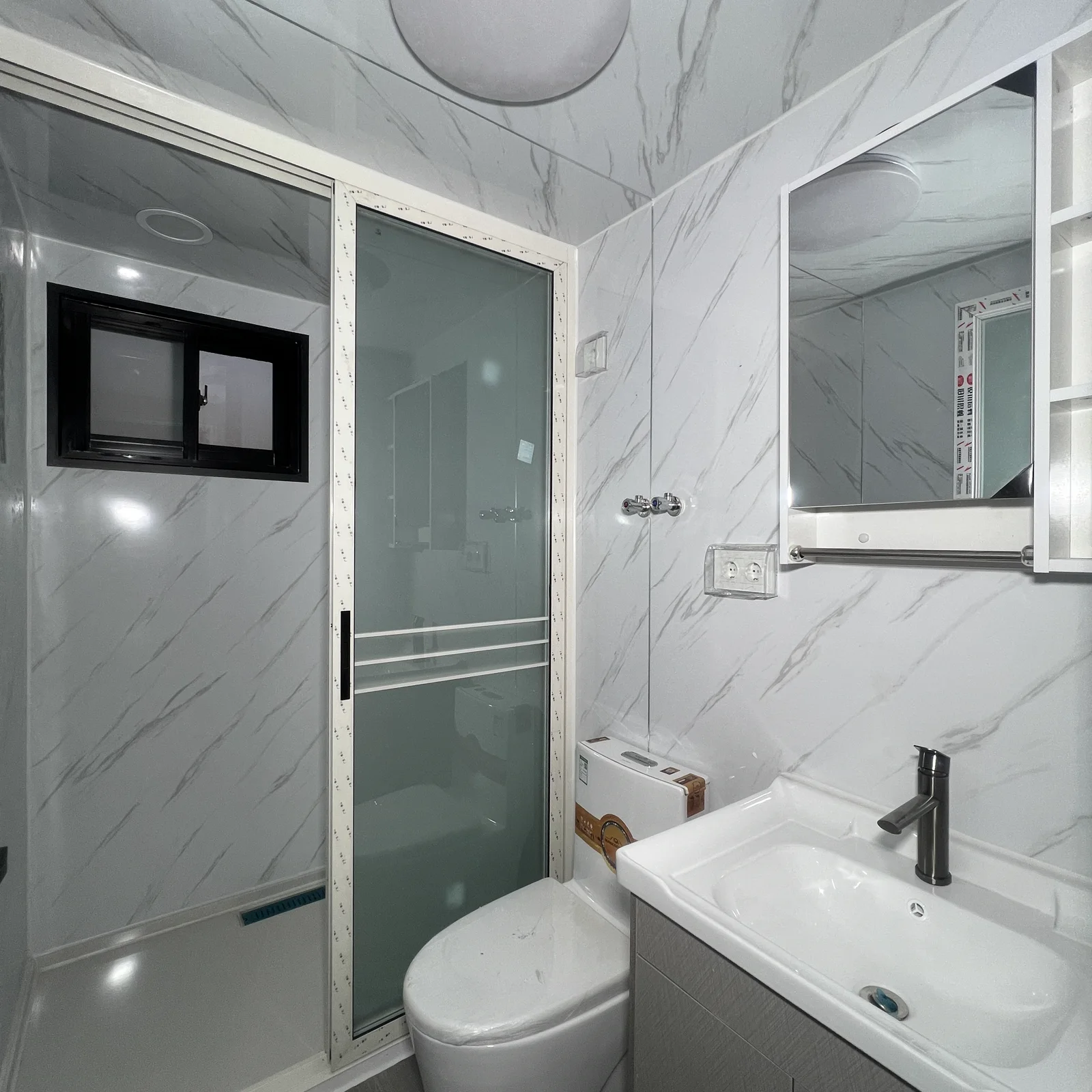 Bathroom with toilet washbasin and shower in a 20ft expandable house