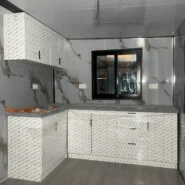 Fitted L-shaped kitchen in a 20ft foldable prefab house