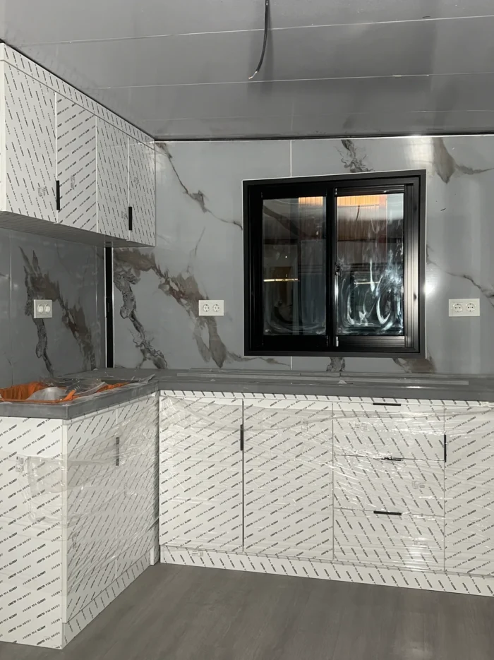 20ft foldable prefab house kitchen Fitted L-shaped kitchen in a 20ft foldable prefab house