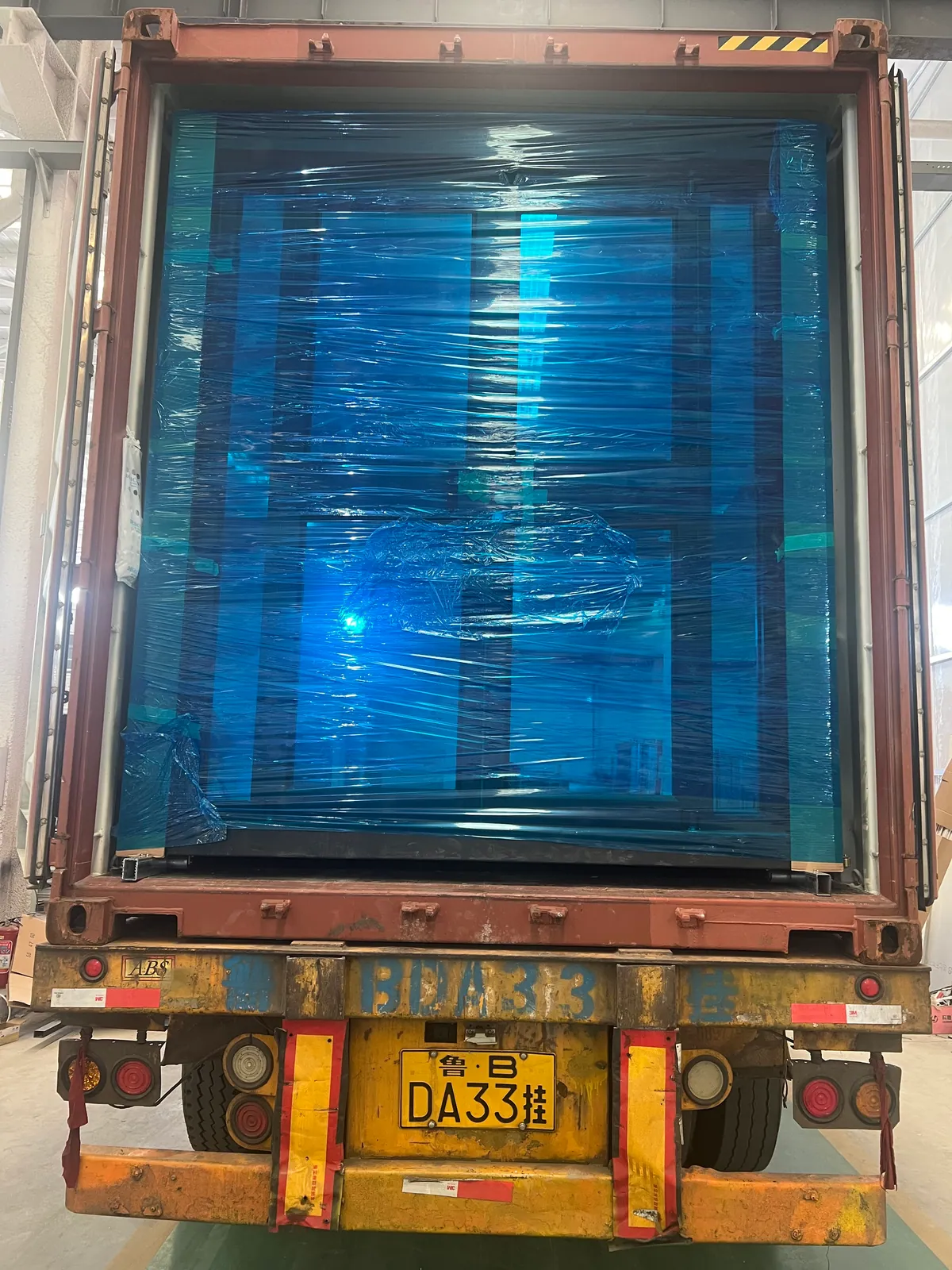 Wrapped 20ft folding house loaded into a shipping container for Miami Florida