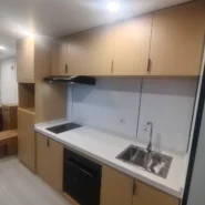 40FT Apple Cabin kitchen interior with cabinets sink and electric cooktop