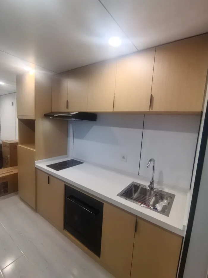 40ft-apple-cabin-kitchen-interior 40FT Apple Cabin kitchen interior with cabinets sink and electric cooktop